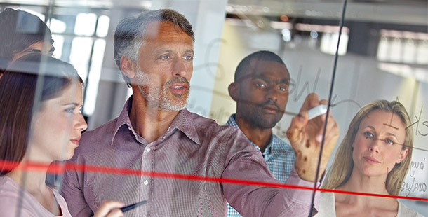 group of people at board in workshop